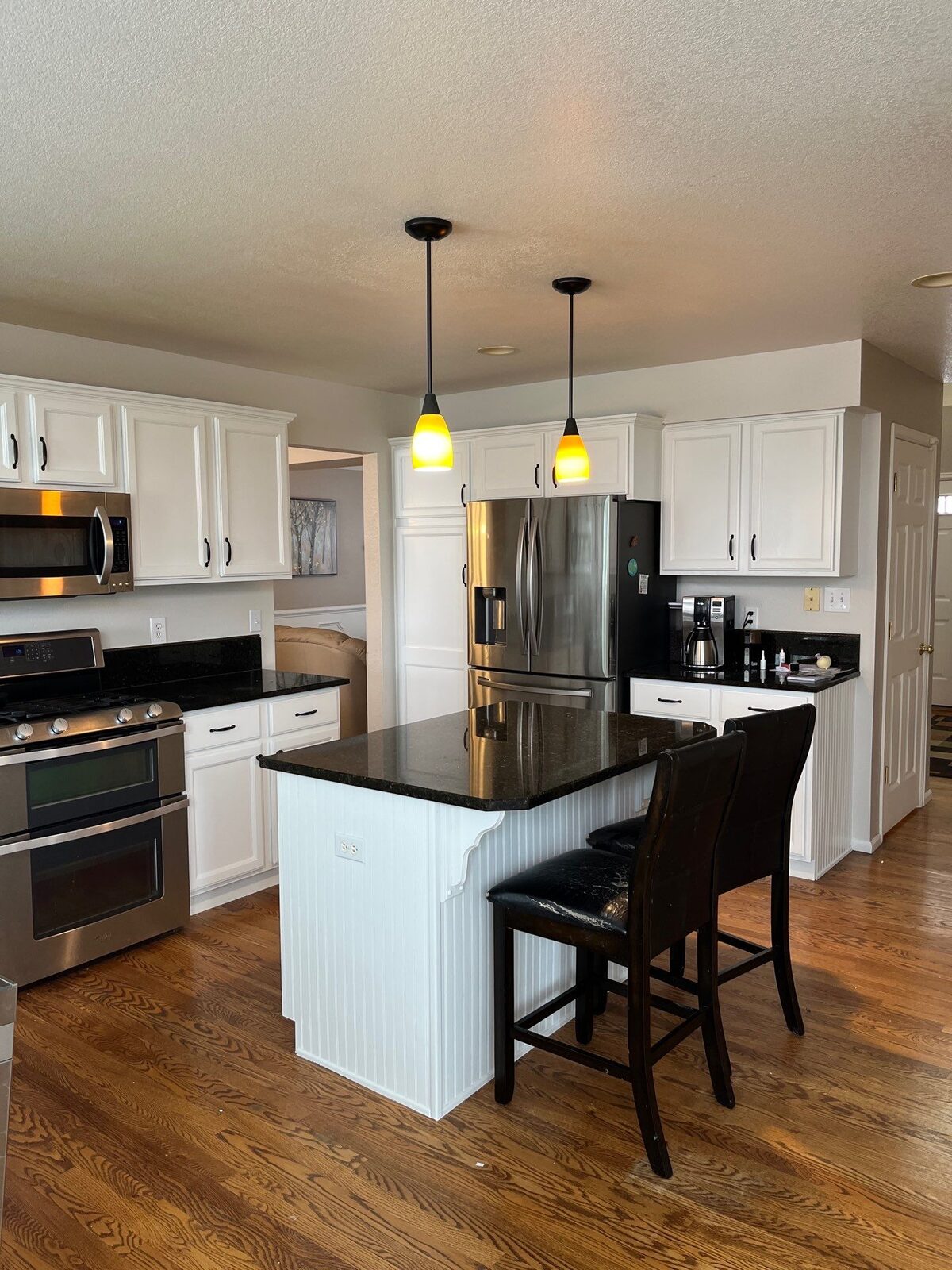A Denver kitchen with freshly repainted cabinets by Kind Home Painting