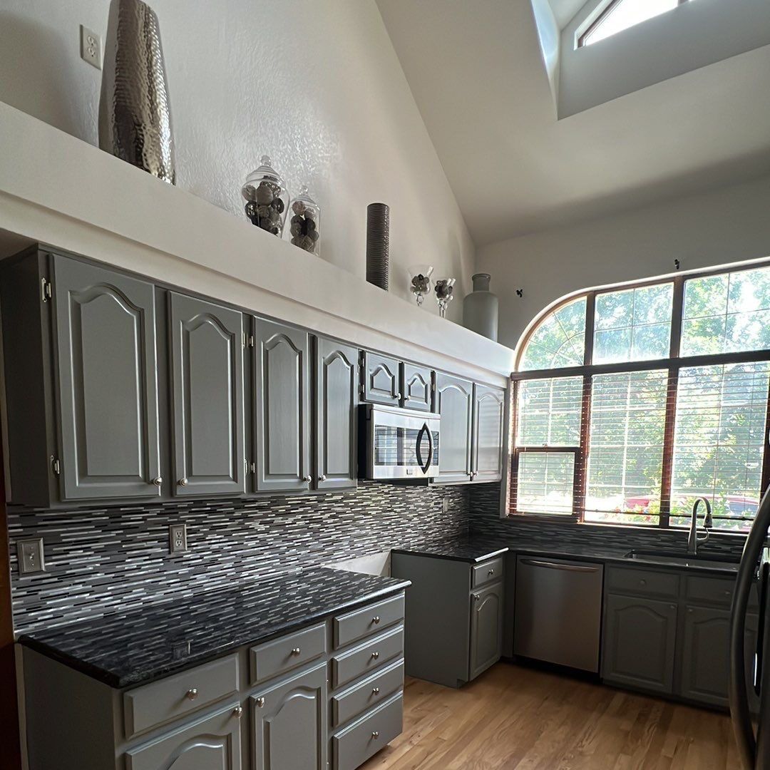 Floor-to-ceiling repainted cabinets around a kitchen window