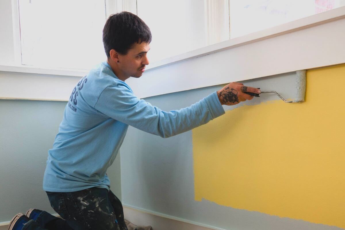 A Kind Home painter hand-detailing interior trim