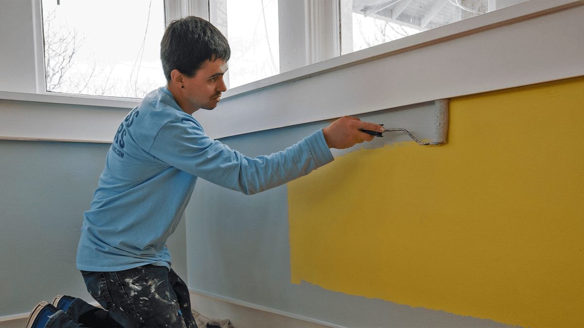 A Kind Home painter cutting in an accent wall